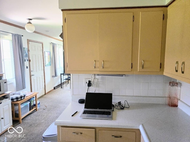 8230 E 11th St, Indianapolis, IN 46219 - kitchen featuring decorative backsplash, crown molding, and light countertops