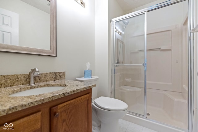 full bath featuring vanity, tile patterned flooring, a stall shower, and toilet