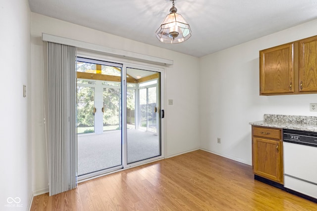 interior space with baseboards and light wood finished floors