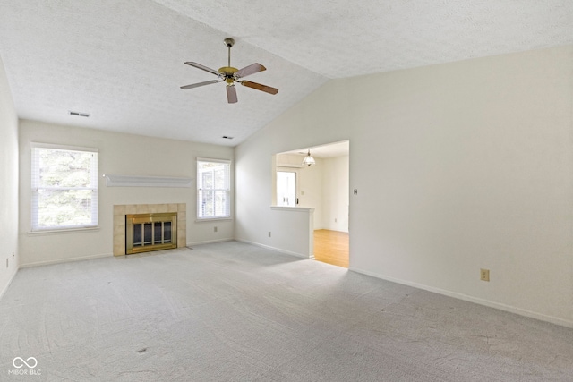unfurnished living room with visible vents, a ceiling fan, plenty of natural light, and light carpet