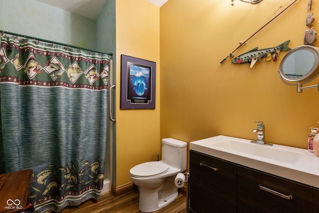 bathroom featuring toilet, a shower with curtain, vanity, and wood finished floors