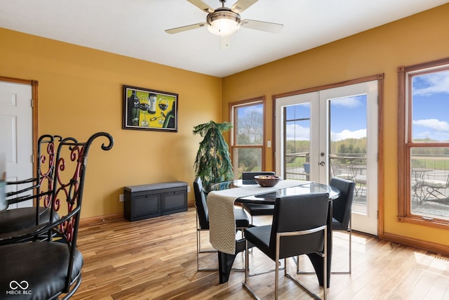 dining space with light wood-type flooring, french doors, and baseboards