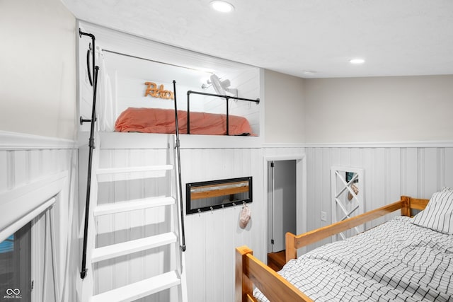 bedroom featuring wainscoting and recessed lighting
