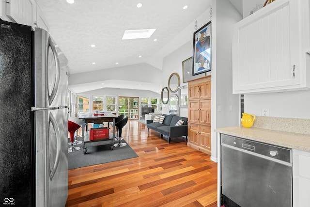 kitchen with light wood-style floors, white cabinets, stainless steel appliances, and recessed lighting
