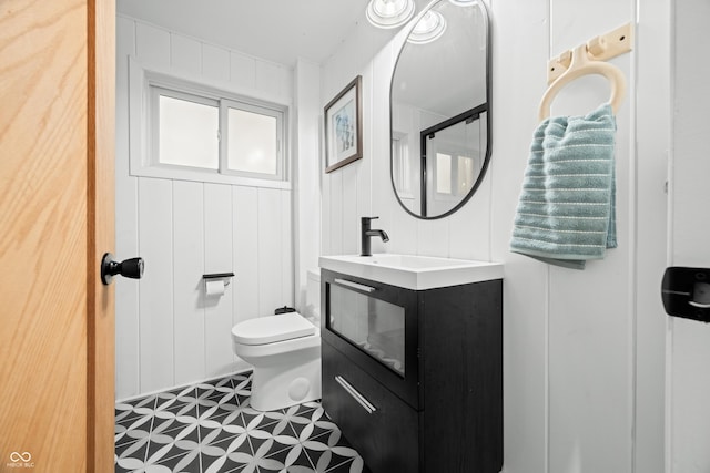 bathroom featuring toilet and vanity