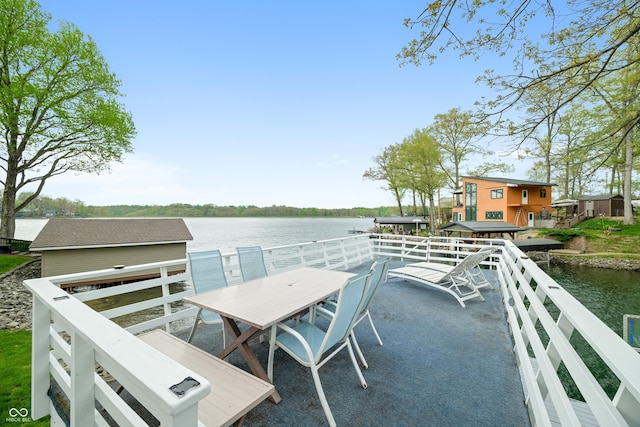 exterior space with a water view and outdoor dining space