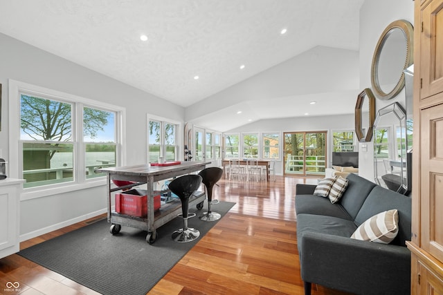 living area with light wood-style floors, recessed lighting, and lofted ceiling