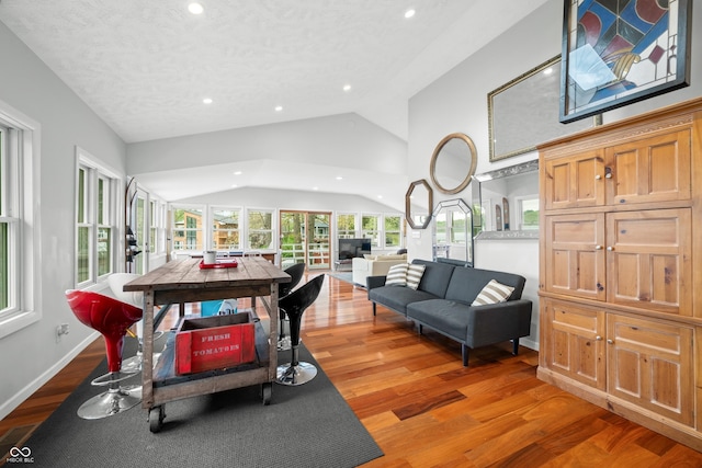 interior space with recessed lighting, a textured ceiling, vaulted ceiling, and light wood-type flooring