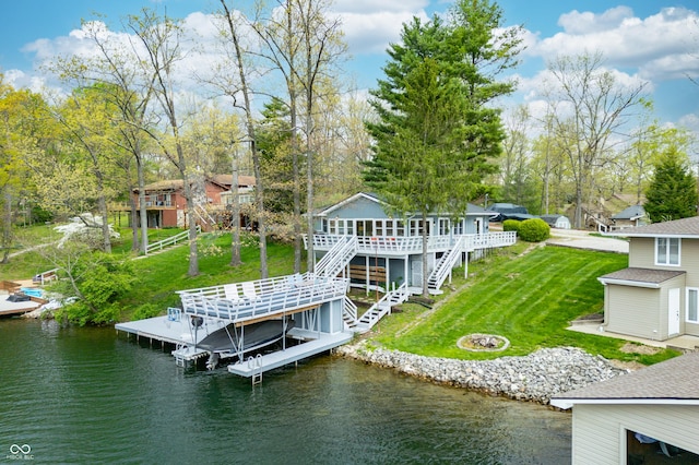 view of dock featuring a deck with water view, boat lift, a yard, and stairway