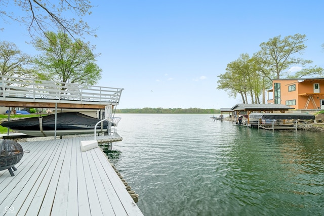 dock area with boat lift and a water view