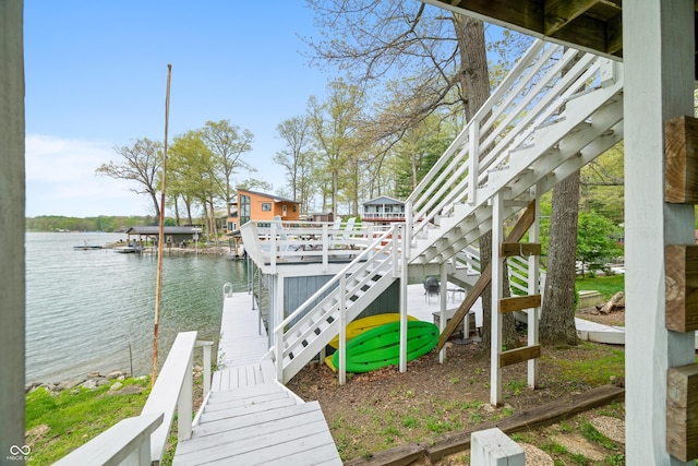 view of dock featuring stairs and a water view