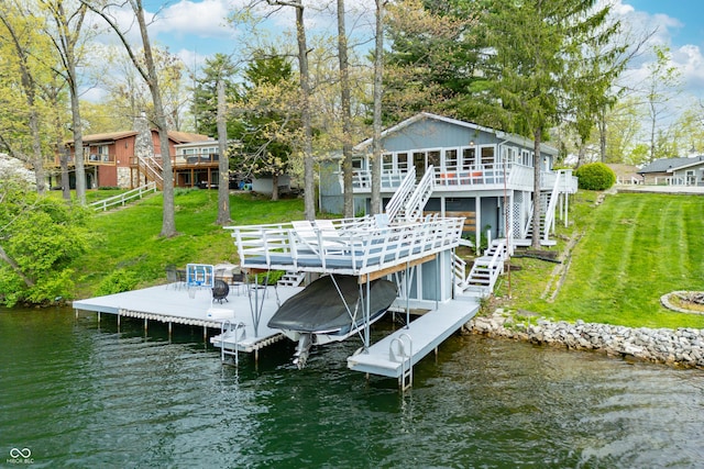 view of dock featuring stairway, boat lift, a yard, and a deck with water view