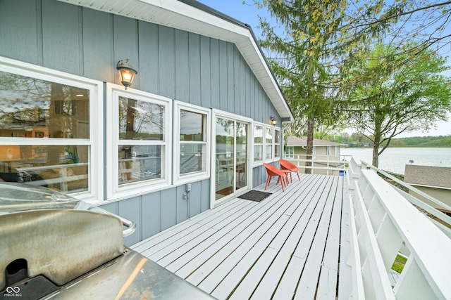 wooden terrace featuring a water view