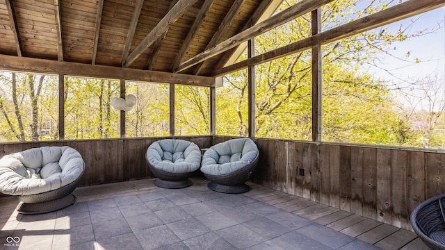 sunroom featuring beam ceiling