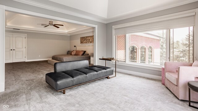 carpeted bedroom featuring baseboards, ornamental molding, and a tray ceiling