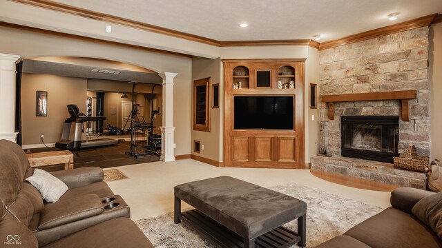 living room featuring a fireplace, baseboards, crown molding, and ornate columns