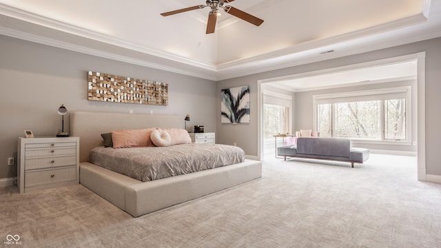 bedroom featuring carpet floors, crown molding, and a tray ceiling