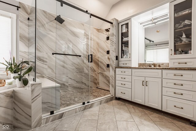 full bathroom featuring a shower stall, marble finish floor, a wealth of natural light, and vanity