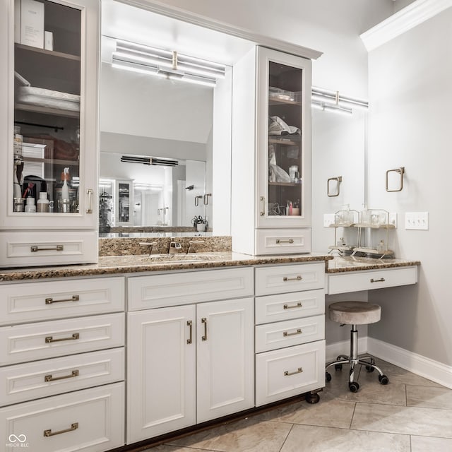 full bath with tile patterned floors, baseboards, and vanity