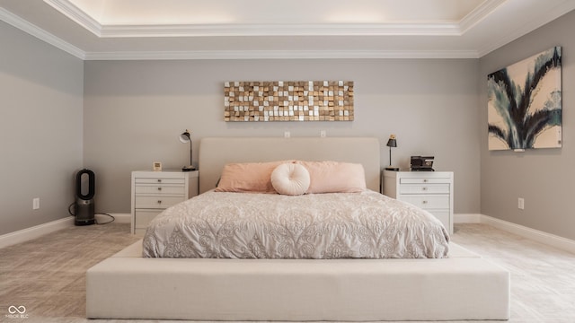 bedroom with a tray ceiling, light colored carpet, and ornamental molding