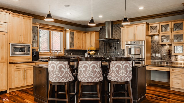 kitchen featuring crown molding, wall chimney exhaust hood, light brown cabinetry, and appliances with stainless steel finishes