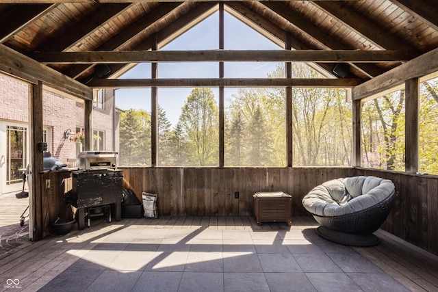 sunroom / solarium with beam ceiling and a healthy amount of sunlight