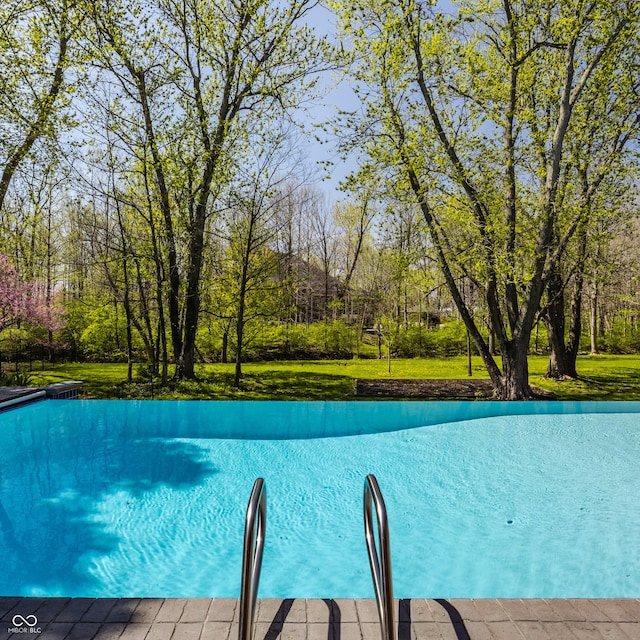 view of pool featuring a yard