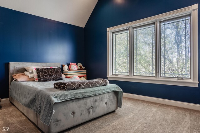 carpeted bedroom featuring vaulted ceiling and baseboards