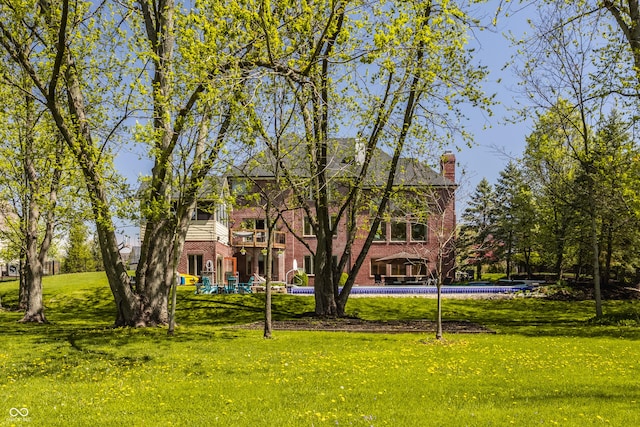 view of community featuring a pool and a yard