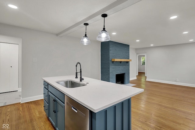 4775 E 56th St, Indianapolis, IN 46220 - kitchen featuring stainless steel dishwasher, light wood-style flooring, a sink, baseboards, and pendant lighting