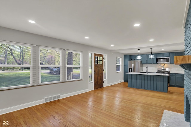 4775 E 56th St, Indianapolis, IN 46220 - unfurnished living room featuring recessed lighting, visible vents, light wood-style flooring, and baseboards