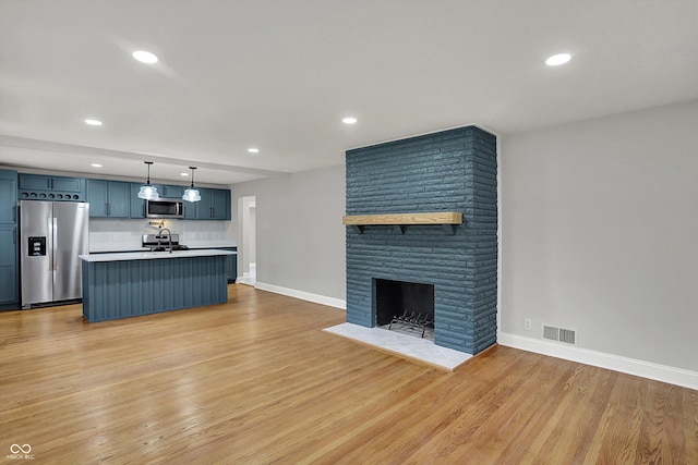 4775 E 56th St, Indianapolis, IN 46220 - unfurnished living room featuring recessed lighting, light wood finished floors, visible vents, and baseboards