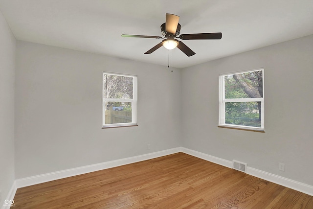 4775 E 56th St, Indianapolis, IN 46220 - empty room with baseboards, visible vents, wood finished floors, and a ceiling fan