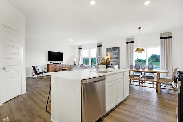 kitchen featuring recessed lighting, a sink, a center island with sink, white cabinetry, and dishwasher
