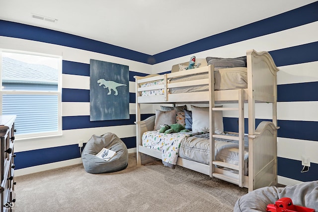 carpeted bedroom featuring visible vents and baseboards