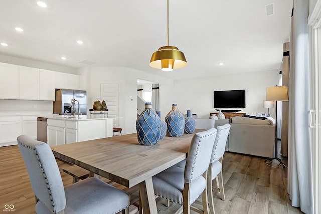 dining space with recessed lighting, visible vents, and light wood-style floors
