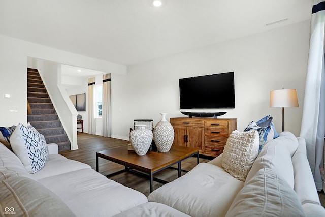 living room featuring recessed lighting, stairs, visible vents, baseboards, and wood finished floors