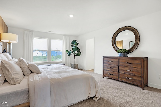 bedroom with baseboards, recessed lighting, and light carpet