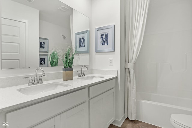 full bath featuring toilet, double vanity, a sink, and shower / tub combo with curtain