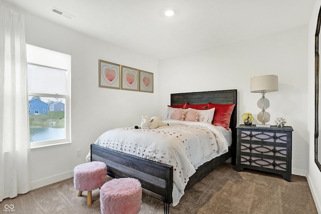 carpeted bedroom featuring visible vents and baseboards