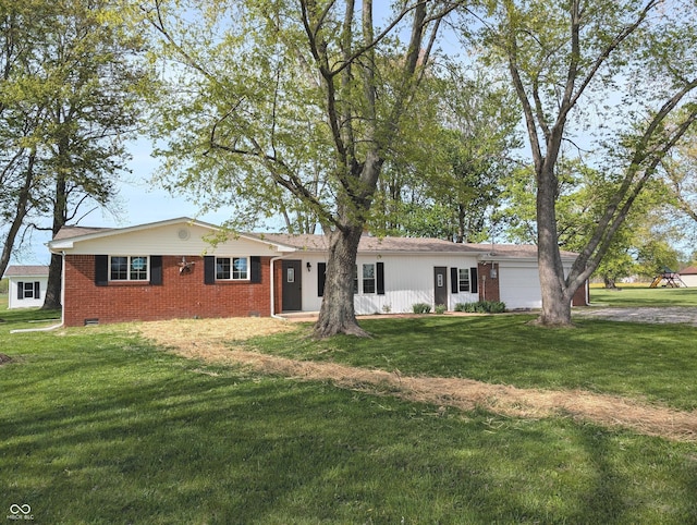 ranch-style house with an attached garage, brick siding, and a front lawn