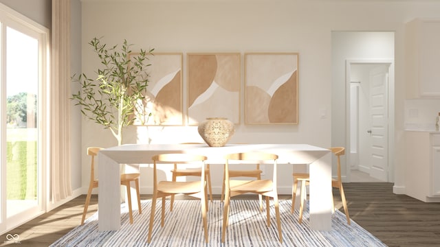 dining space featuring wood finished floors and baseboards