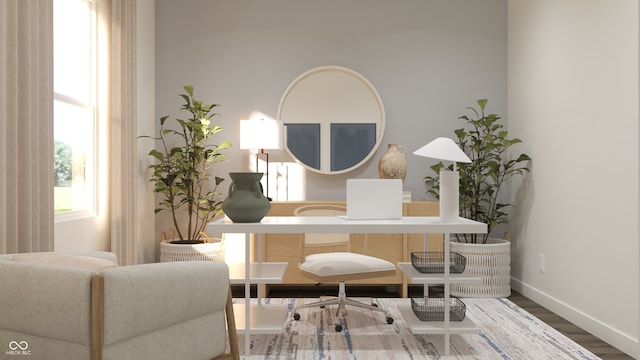 living area with wood finished floors and baseboards