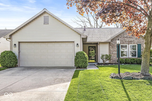 ranch-style house featuring an attached garage, roof with shingles, a front yard, and concrete driveway