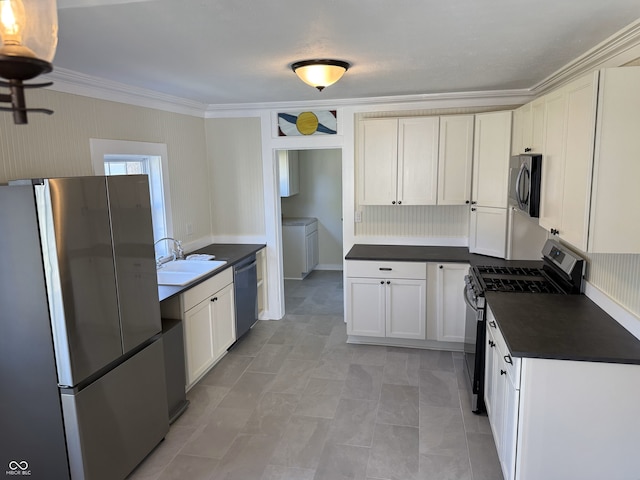1378 Hannibal St, Noblesville, IN 46060 - kitchen with dark countertops, a sink, crown molding, separate washer and dryer, and appliances with stainless steel finishes