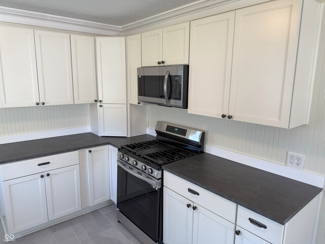 1378 Hannibal St, Noblesville, IN 46060 - kitchen featuring stainless steel appliances, white cabinetry, and dark countertops