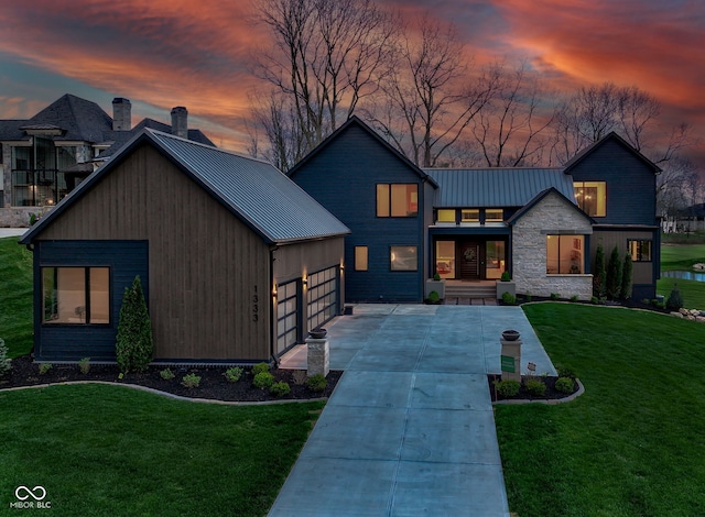 1333 Chatham Rdg Ct, Westfield, IN 46074 - view of front facade featuring an attached garage, metal roof, a front yard, and a standing seam roof