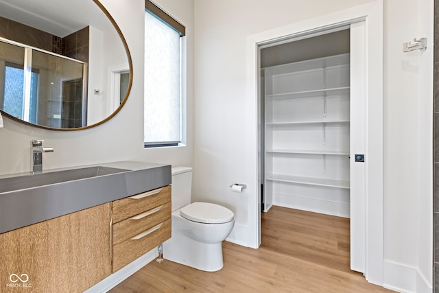 1333 Chatham Rdg Ct, Westfield, IN 46074 - bathroom with vanity, toilet, baseboards, wood finished floors, and a stall shower