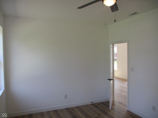 empty room with a ceiling fan, wood finished floors, and baseboards