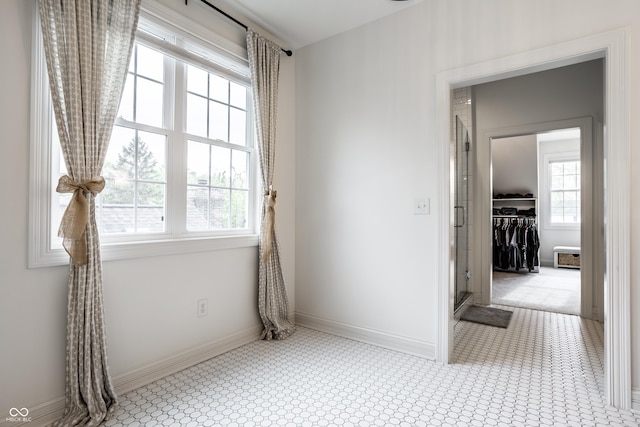unfurnished room featuring baseboards